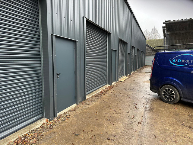 Row of commercial units with roller doors