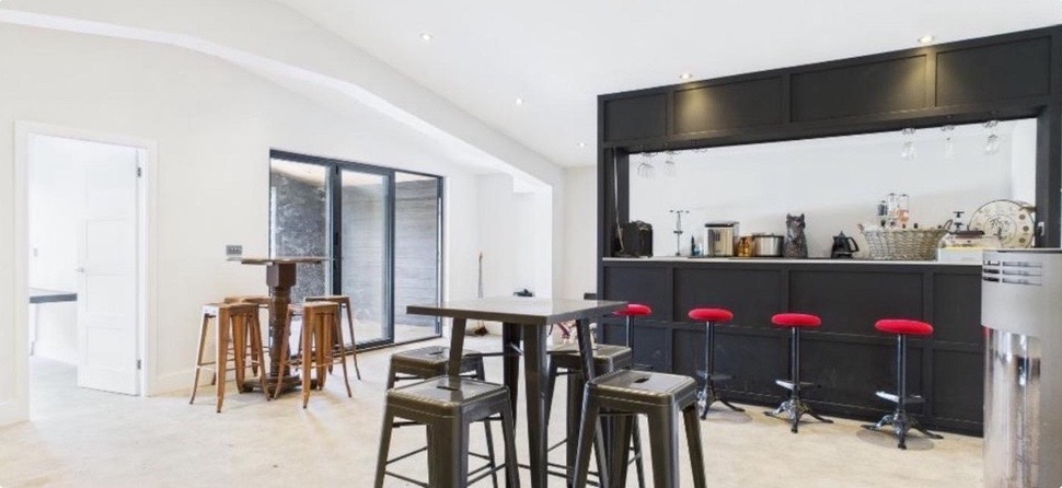 Bright interior with a bar and high stools