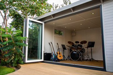 Music room with open bifold doors