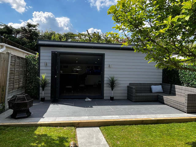 Grey-clad garden build with patio and seating