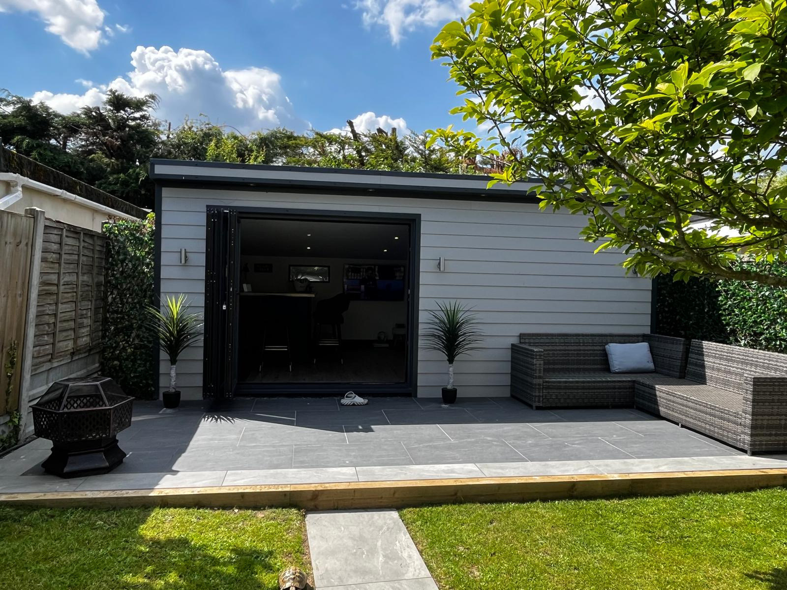 A grey-clad Bentley build with patio and outdoor seating
