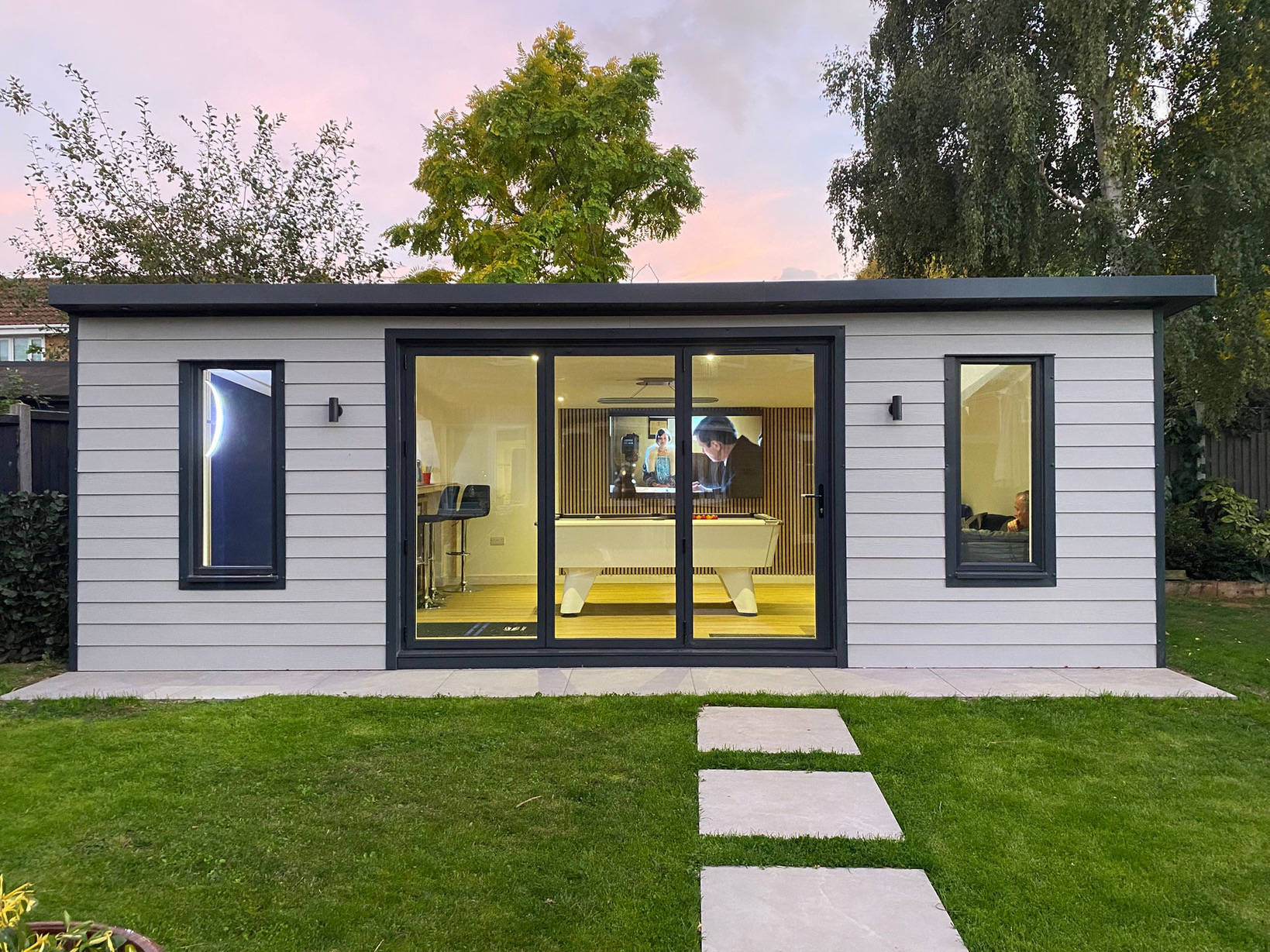 A finished Bentley build at dusk with large glazed doors