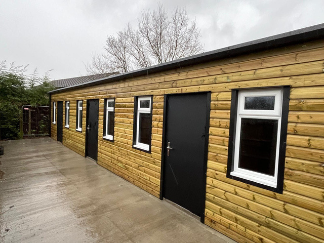 Timber-clad build with black doors